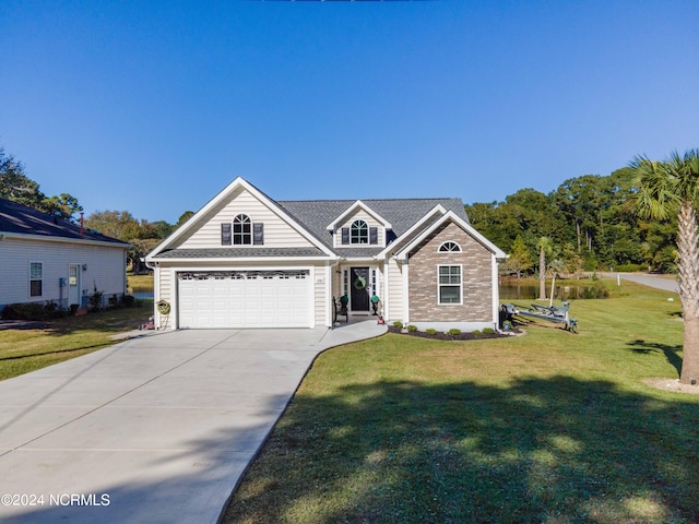 view of front of house featuring a front lawn and a garage