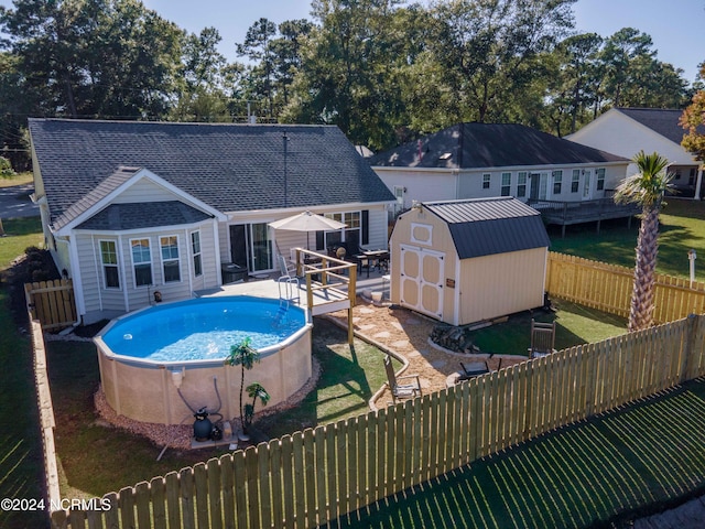 view of pool with a yard, a shed, and a patio area