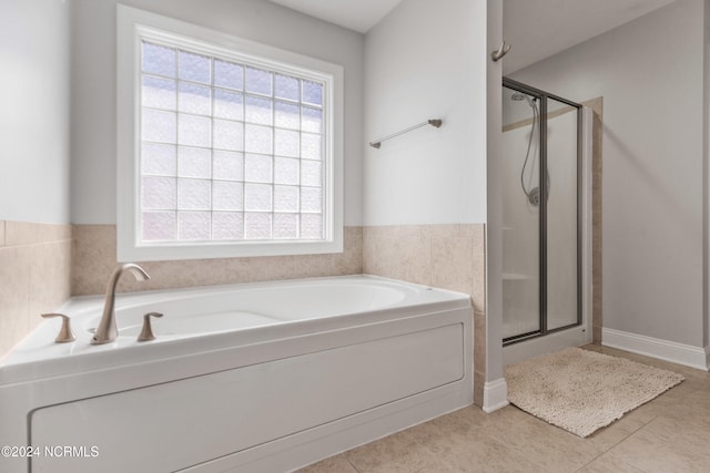 bathroom featuring plus walk in shower and tile patterned flooring