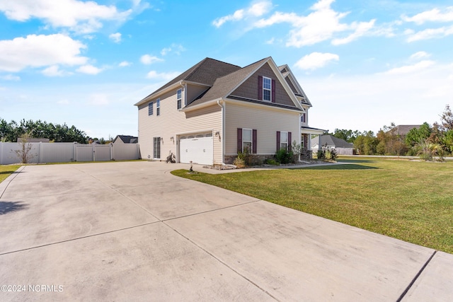 view of front of home with a garage and a front lawn