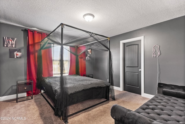 bedroom featuring carpet and a textured ceiling