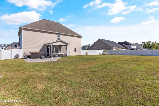 back of house featuring a patio area and a lawn