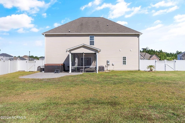 back of property with a patio area, a yard, and a sunroom