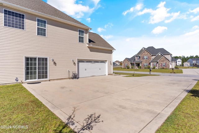 view of home's exterior featuring a lawn and a garage