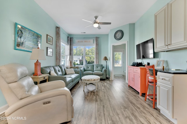 living room featuring light wood-type flooring and ceiling fan