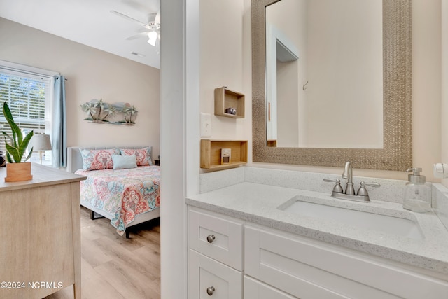 bathroom featuring hardwood / wood-style flooring, vanity, and ceiling fan