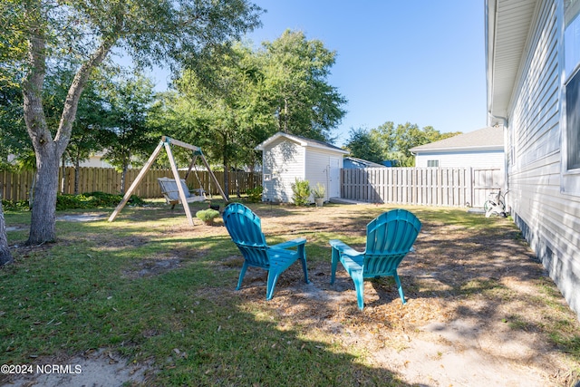 view of yard featuring a shed and a playground