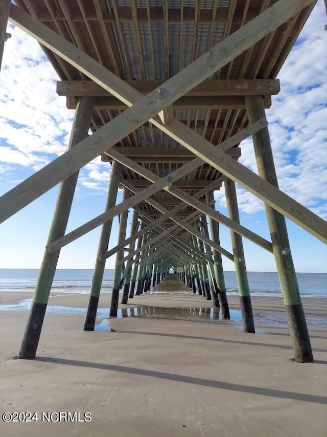 surrounding community with a view of the beach and a water view