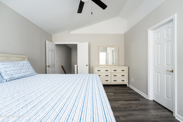 bedroom with dark hardwood / wood-style floors, vaulted ceiling, and ceiling fan