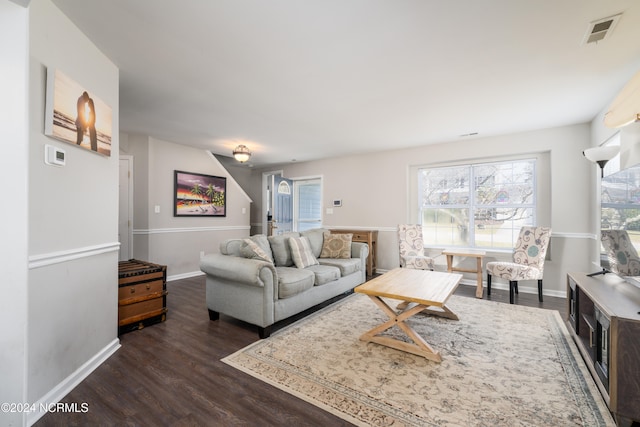 living room with dark hardwood / wood-style flooring