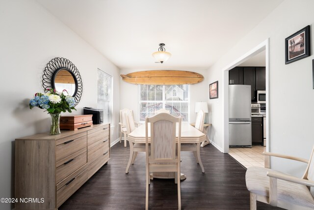 dining space with dark hardwood / wood-style floors