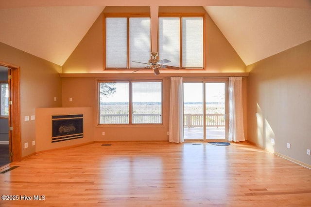 unfurnished living room featuring high vaulted ceiling, ceiling fan, and light wood-type flooring