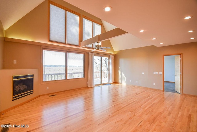 unfurnished living room with lofted ceiling, light wood-type flooring, and ceiling fan