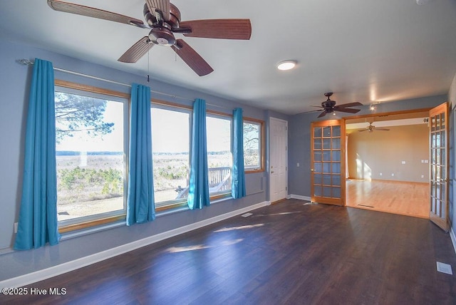 unfurnished living room featuring french doors and dark hardwood / wood-style flooring