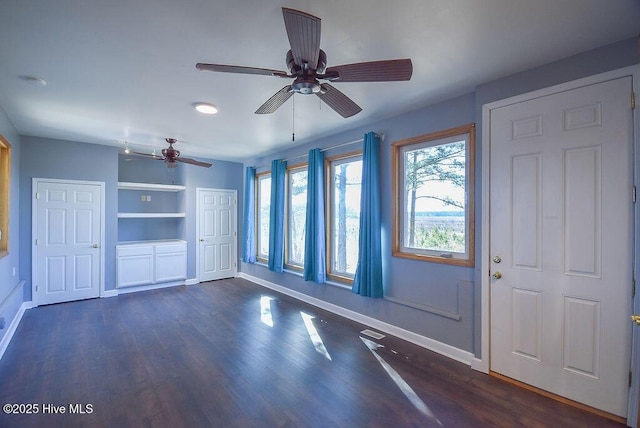 interior space with ceiling fan, dark hardwood / wood-style flooring, and built in features