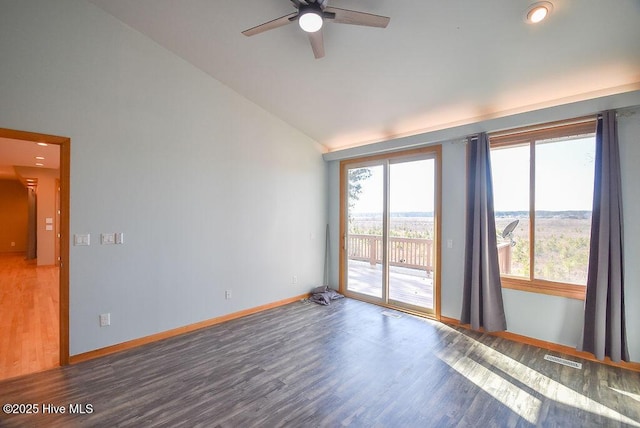 unfurnished room featuring lofted ceiling, dark hardwood / wood-style flooring, and ceiling fan