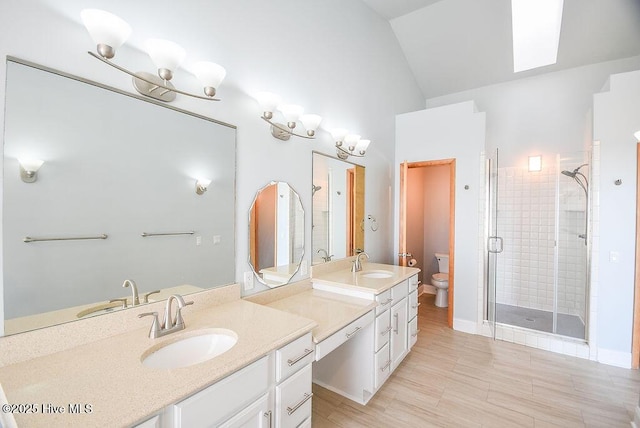 bathroom featuring toilet, vanity, walk in shower, and lofted ceiling