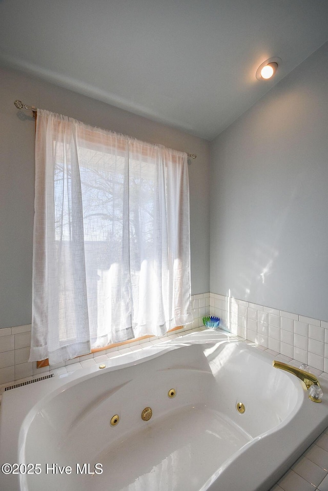 bathroom with tiled tub