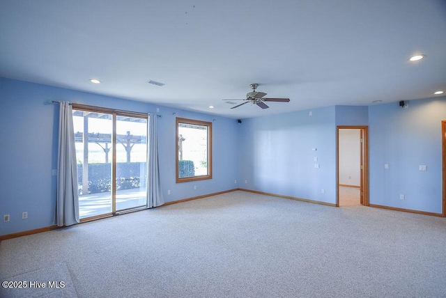 carpeted empty room featuring ceiling fan