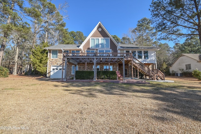 view of front of home with a deck, a front lawn, and a garage