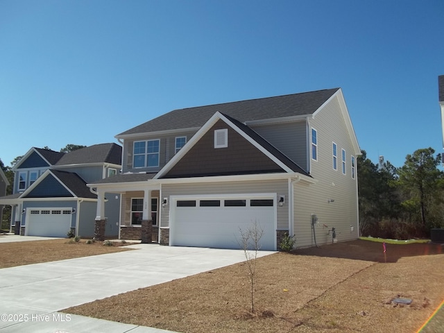 craftsman-style home featuring concrete driveway and stone siding