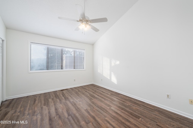 unfurnished room with visible vents, baseboards, dark wood finished floors, lofted ceiling, and ceiling fan