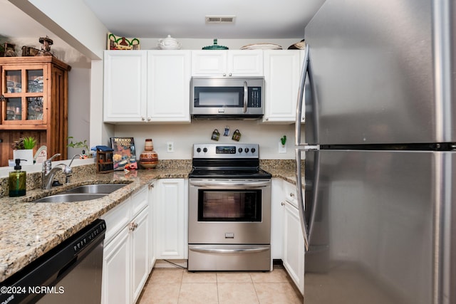 kitchen featuring stainless steel appliances, visible vents, white cabinets, a sink, and light tile patterned flooring