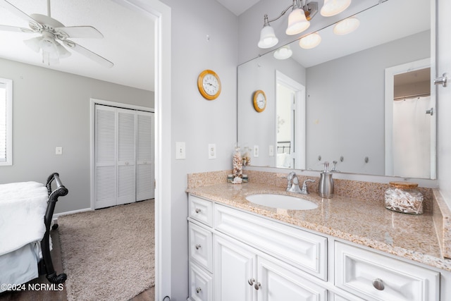 full bath featuring baseboards, a ceiling fan, and vanity