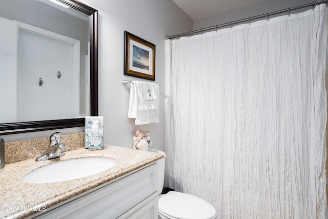 full bathroom featuring vanity and toilet