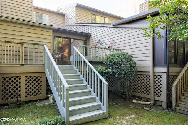 entrance to property featuring a wooden deck