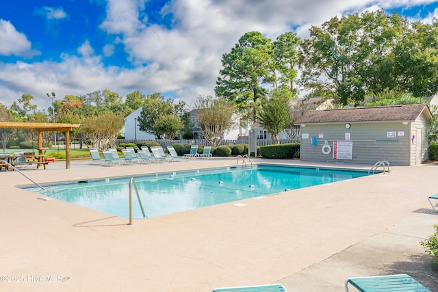 community pool featuring a patio and fence