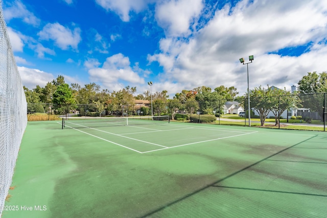 view of tennis court featuring fence