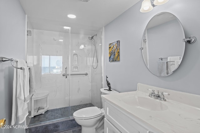 bathroom featuring vanity, tile patterned floors, toilet, and an enclosed shower