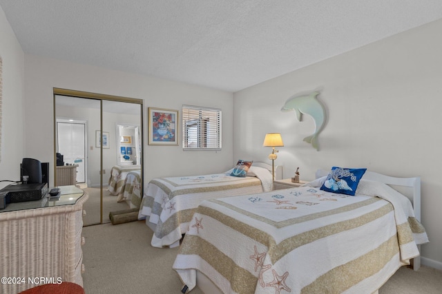 carpeted bedroom with a closet and a textured ceiling