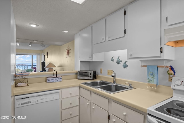 kitchen with a textured ceiling, white cabinets, sink, and white appliances