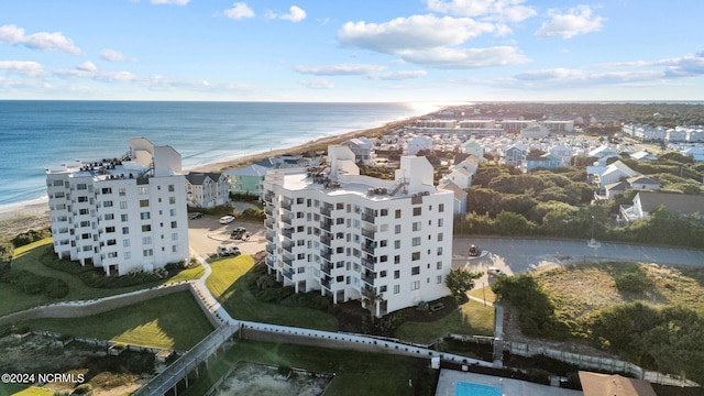 drone / aerial view featuring a water view and a view of the beach