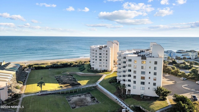 birds eye view of property with a water view and a view of the beach