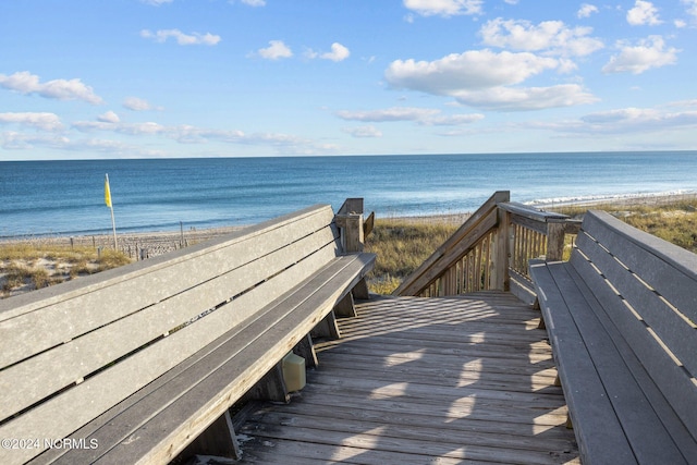 view of community featuring a water view and a beach view