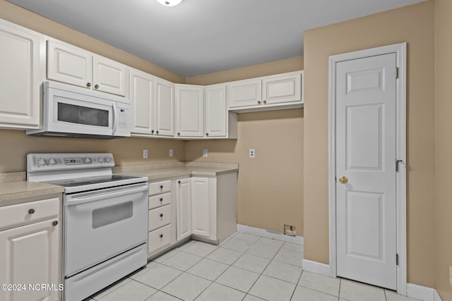 kitchen featuring white appliances and white cabinetry