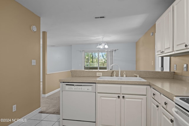 kitchen with kitchen peninsula, sink, a notable chandelier, white cabinetry, and white appliances