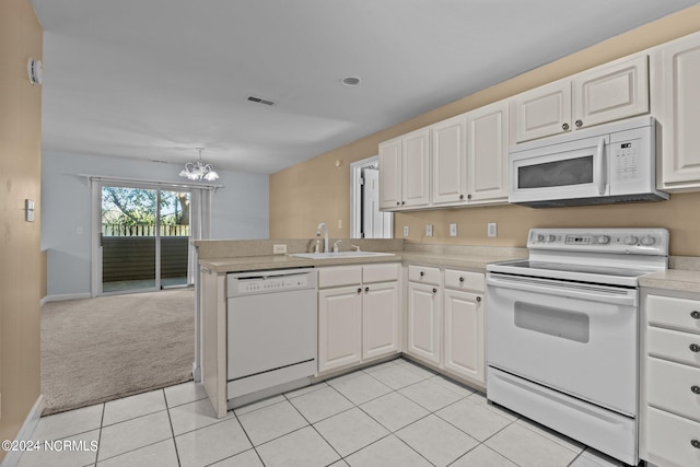 kitchen featuring white cabinets, kitchen peninsula, and white appliances