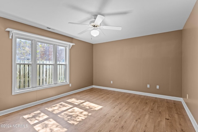 empty room with light hardwood / wood-style flooring and ceiling fan