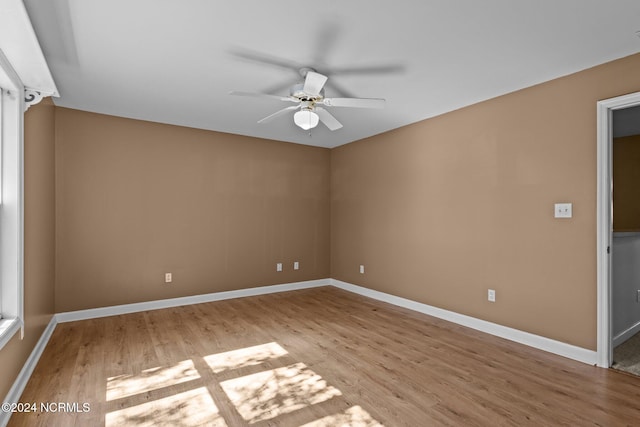 empty room with light hardwood / wood-style flooring and ceiling fan