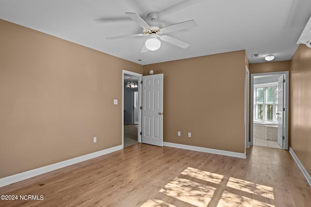 unfurnished bedroom with light hardwood / wood-style flooring, connected bathroom, and ceiling fan