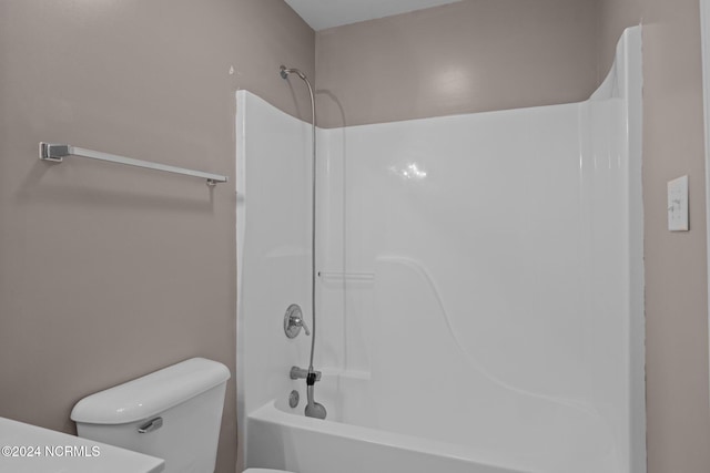 bathroom with shower / bathing tub combination and toilet