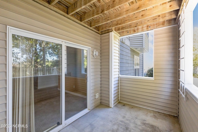 unfurnished sunroom with wooden ceiling