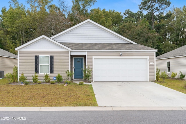 view of front of house with a front yard, a garage, and cooling unit