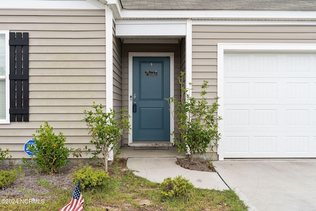 view of exterior entry featuring a garage