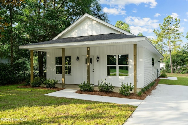 view of front of house with a porch and a front lawn