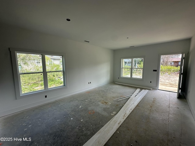 empty room with baseboards and visible vents